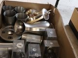 a cardboard box filled with a variety of kitchen utensils