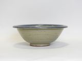 a small bowl that is sitting on a white surface