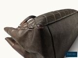 brown leather handbag on white background with blue and white background