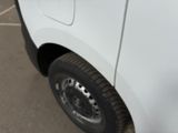 a close up of a white truck parked in a parking lot