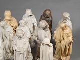 several figurines of people dressed in medieval clothing and hats