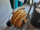 a cart with a hose on it in a garage