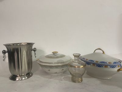 a silver vase, a silver cup, and a silver vase on a table