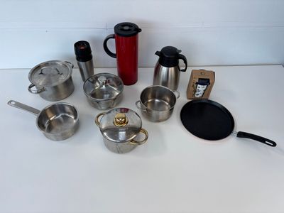 a lot of pots and pans that are on the table