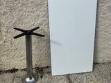 a mirror and a metal pole next to a wall