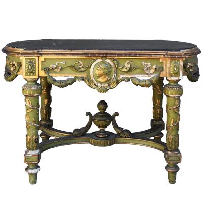 a green table with a black top and a gold base
