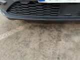 the front bumper of a car with a license plate on it