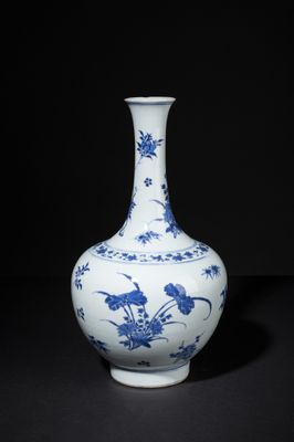 blue and white vase with birds and flowers on a black background