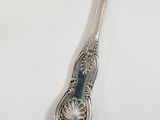 a silver spoon with a blue handle on a white table