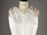 an image of a mannequin with a white blouse on a mannequin stand