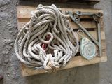 a pile of rope sitting on a pallet next to a pair of scissors
