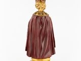 a close up of a statue of a person wearing a cape