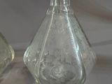 two glass vases that are sitting next to each other