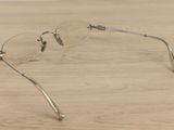 a pair of glasses sitting on a wooden table