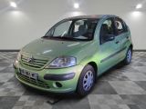 a picture of a green car parked in a garage