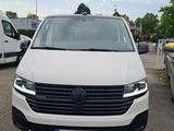 the front of a white van parked in a parking lot