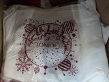 a white bag with a red design on it sitting inside of a box