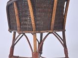 a wicker chair that is sitting on a white surface