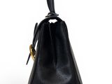 a black leather handbag on a white background