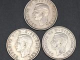 three british silver coins, one of which has a crown and the other of which is a sovereign