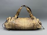 an image of a snake skin handbag on a gray background