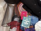 a basket full of clothes and a book on a bed