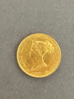 a close up of a gold coin with a woman ' s head on it