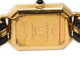 an image of a gold watch with a black leather band