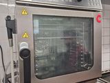 a large oven that is in a kitchen with a lot of pots and pans