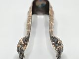 an image of a silver spoon on a white surface