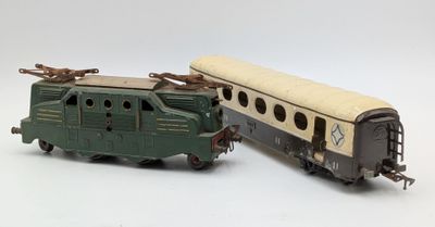 two toy trains sitting next to each other on a white surface