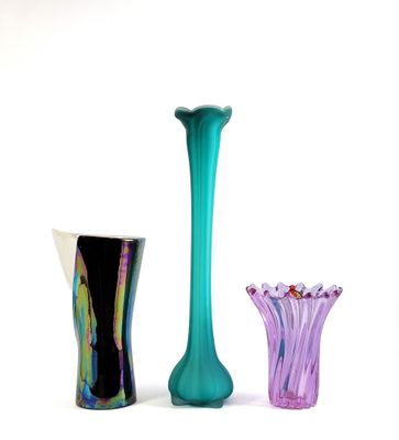 three vases sitting next to each other on a white surface