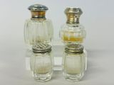 two salt and pepper shakers sitting on a clear plate