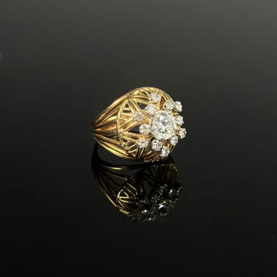 an image of a gold and diamond ring on a black surface