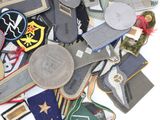 a pile of assorted military patches on a white surface