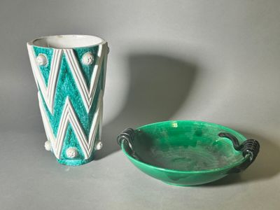 a green bowl next to a green vase on a table