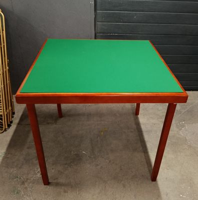a small table with a green top on a concrete floor
