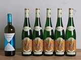 six bouteilles de vin posées sur une table à côté d'une bouteille de vin