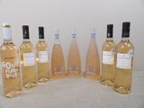 several bottles of wine are lined up on a table