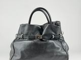 a black leather handbag on a white background