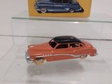 two toy cars on display in a glass case