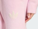 the little girl is wearing a pink sweater and pink leggings