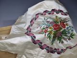 a white pillow with a floral design on it