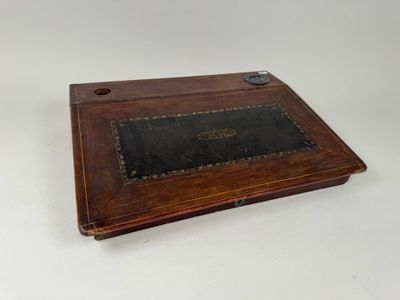 an old wooden box with a leather cover on it