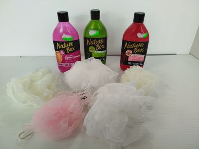 three bottles of bath products sitting on a table