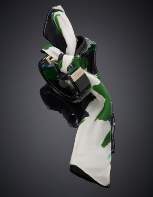 l'écharpe verte et blanche est attachée à un sac à main noir