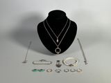 necklaces, bracelets, rings, and other jewelry are displayed on a mannequin