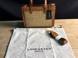 a brown and white bag sitting on top of a wooden table