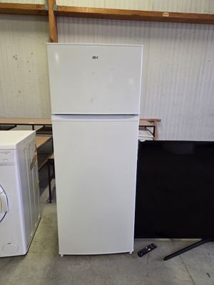two refrigerators and a washing machine in a room