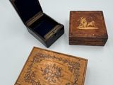 three small wooden boxes sitting on top of a white table